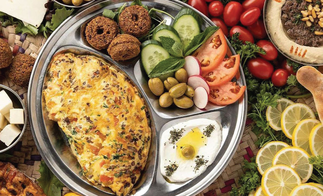 Breakfast platter with omelette, falafel, hummus and vegetables
