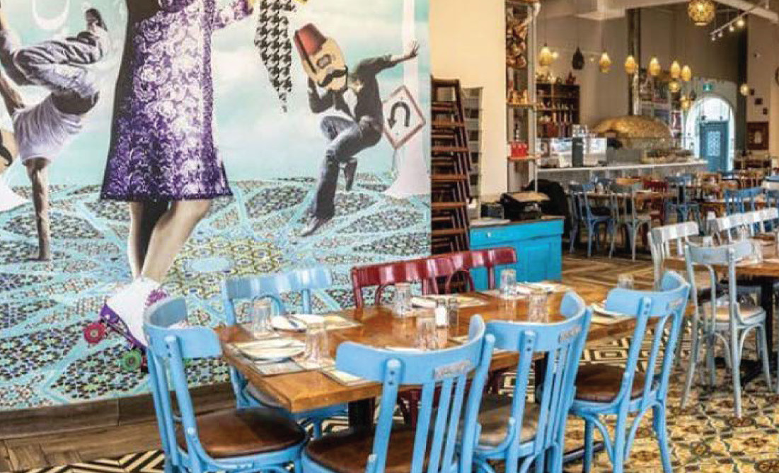 Cafe interior with a wall mural and set tables