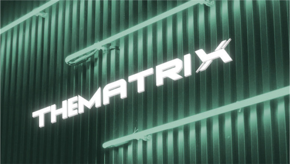 Neon 'THE MATRIX' sign on a ribbed green wall