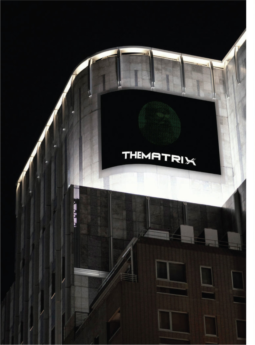 Building facade with lit 'THE MATRIX' billboard at night